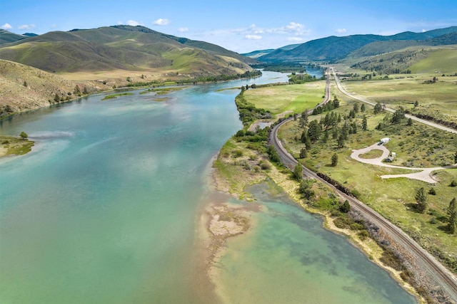 drone / aerial view with a water and mountain view