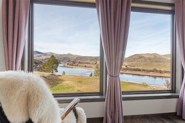 interior details with baseboards and a water and mountain view