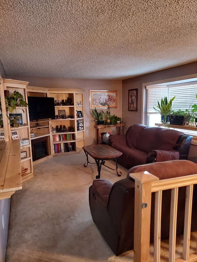 carpeted living room with a textured ceiling and a fireplace