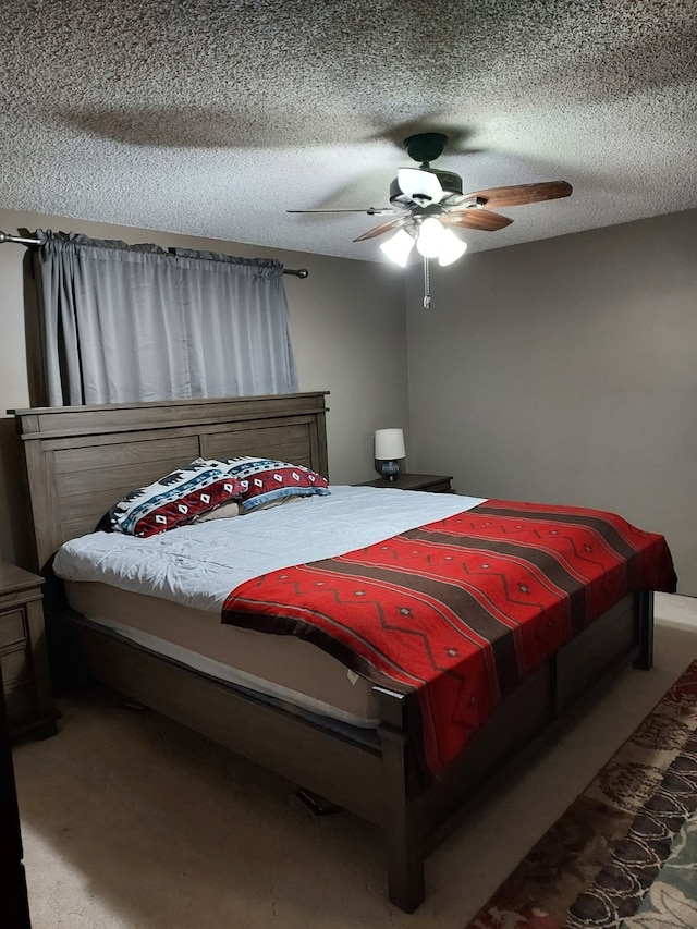 bedroom featuring a ceiling fan, carpet, and a textured ceiling