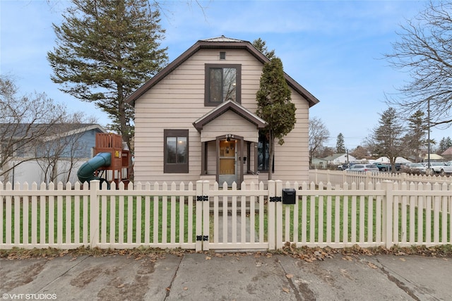 bungalow-style house featuring a playground, a gate, and a fenced front yard