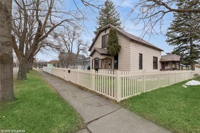 view of side of property with a fenced front yard and a yard