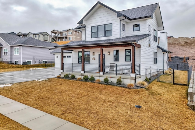 modern farmhouse with a porch, a gate, fence, and a front yard