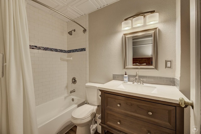 bathroom with vanity, toilet, a textured wall, and shower / bath combo with shower curtain