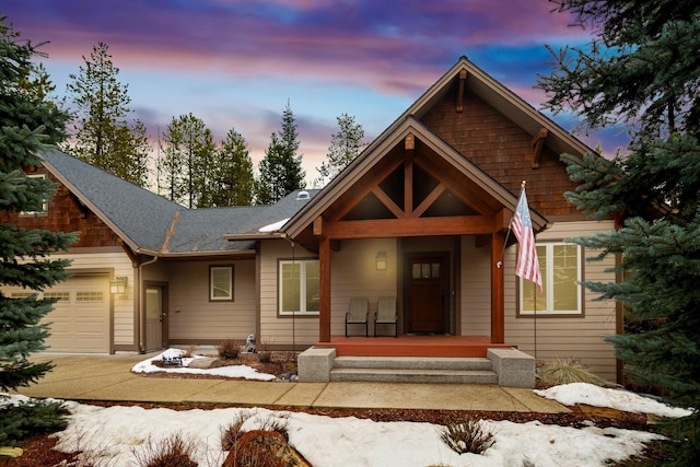 view of front of house featuring a porch and a garage