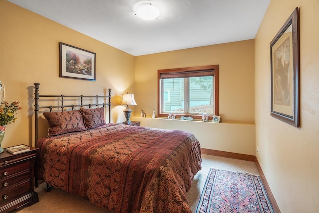 bedroom featuring baseboards and carpet floors