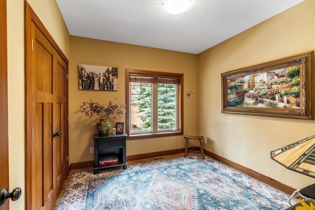 living area featuring baseboards