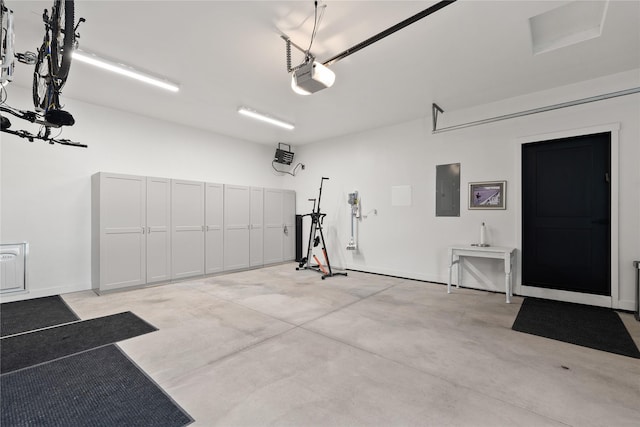 garage with electric panel and a garage door opener