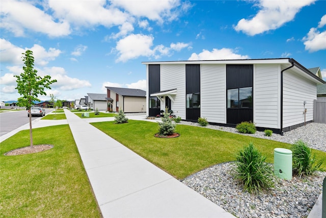 view of front of property featuring a front lawn and a residential view