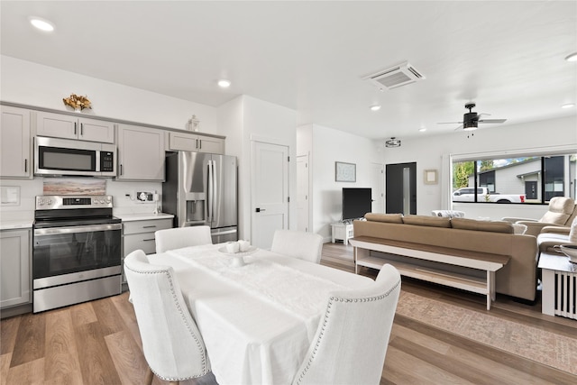 dining area with recessed lighting, light wood-type flooring, visible vents, and ceiling fan