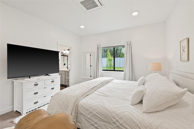 carpeted bedroom featuring recessed lighting, visible vents, baseboards, and ensuite bath