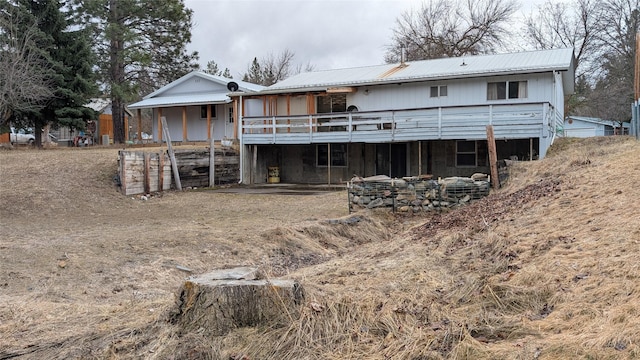 rear view of property featuring metal roof