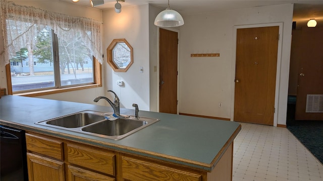 kitchen featuring brown cabinetry, light floors, visible vents, a sink, and dishwasher