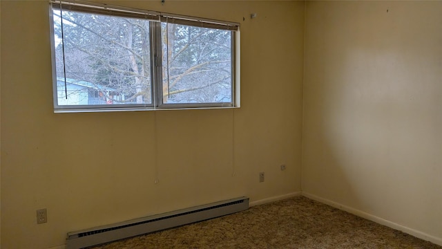 carpeted spare room with a baseboard heating unit, a healthy amount of sunlight, and baseboards