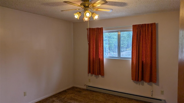 spare room featuring a ceiling fan, baseboards, a textured ceiling, a baseboard heating unit, and dark carpet