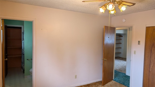 unfurnished bedroom featuring carpet flooring and a textured ceiling