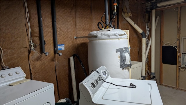 laundry room with gas water heater, washing machine and dryer, and laundry area