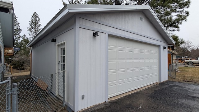 detached garage featuring fence