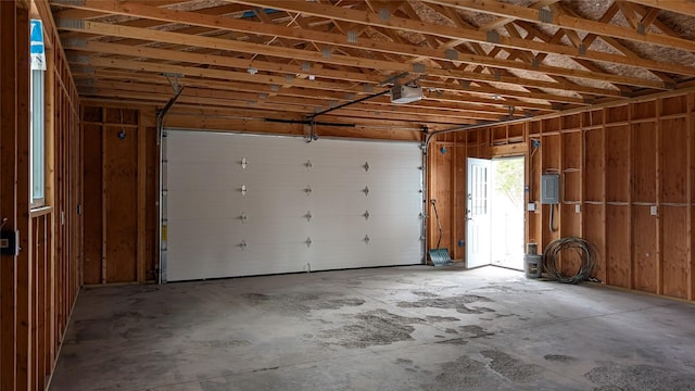 garage featuring electric panel and a garage door opener