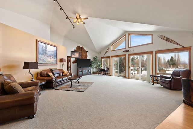 carpeted living room featuring high vaulted ceiling