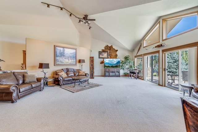 carpeted living room featuring high vaulted ceiling