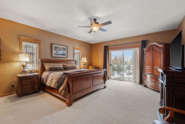 bedroom with baseboards, light carpet, ceiling fan, and access to outside