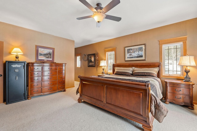 bedroom with light colored carpet, lofted ceiling, and ceiling fan