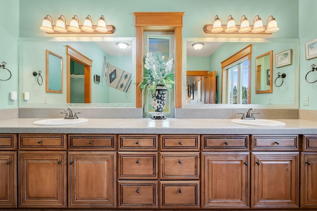 bathroom with a sink and double vanity