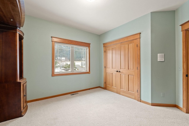 unfurnished bedroom featuring carpet flooring, visible vents, and baseboards