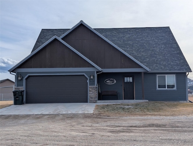 view of front of home with concrete driveway and roof with shingles