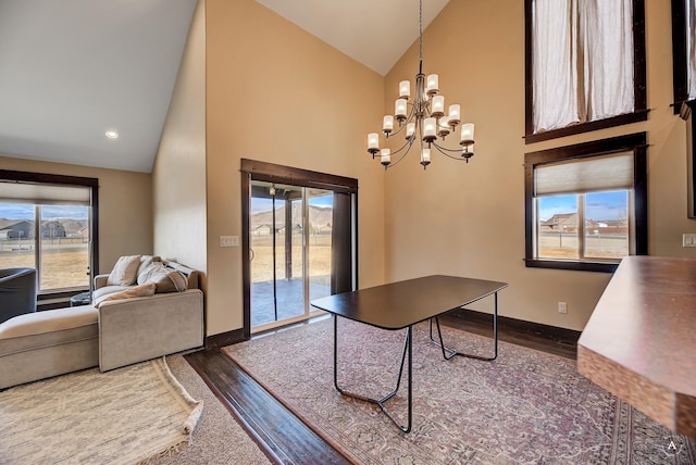 office space with high vaulted ceiling, dark wood-style floors, recessed lighting, an inviting chandelier, and baseboards