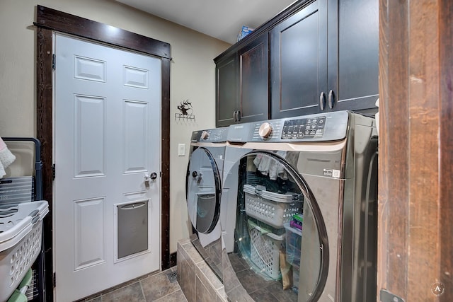 laundry area featuring separate washer and dryer and cabinet space
