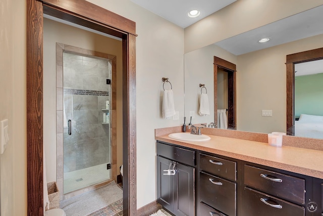 full bathroom with recessed lighting, a stall shower, and vanity