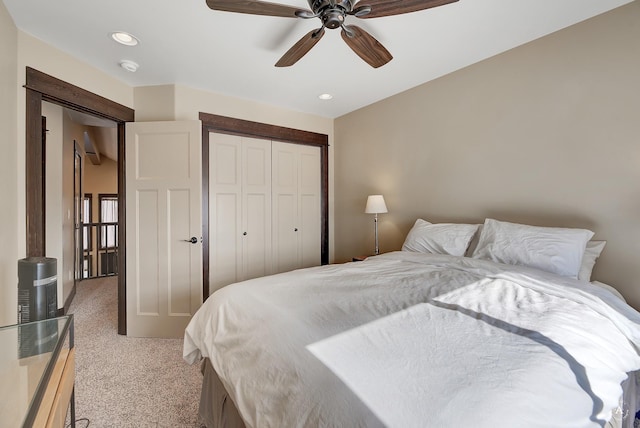 bedroom featuring a ceiling fan, recessed lighting, light colored carpet, and a closet