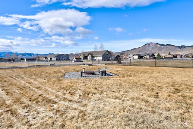 view of yard featuring a mountain view and fence