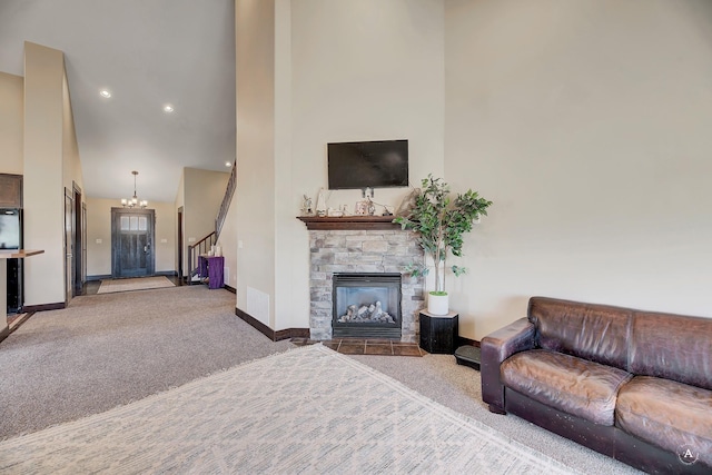 living area featuring stairs, baseboards, a high ceiling, and carpet