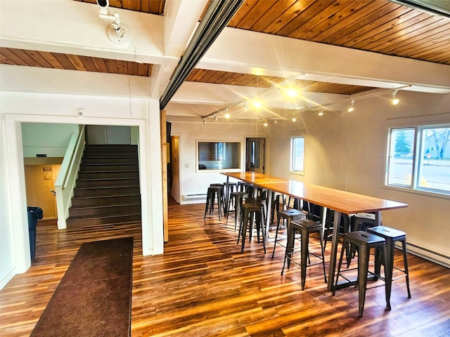 dining area featuring stairway, wood finished floors, and wooden ceiling