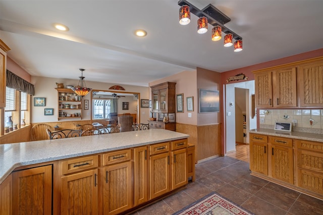 kitchen with light stone countertops, recessed lighting, ceiling fan, decorative backsplash, and hanging light fixtures