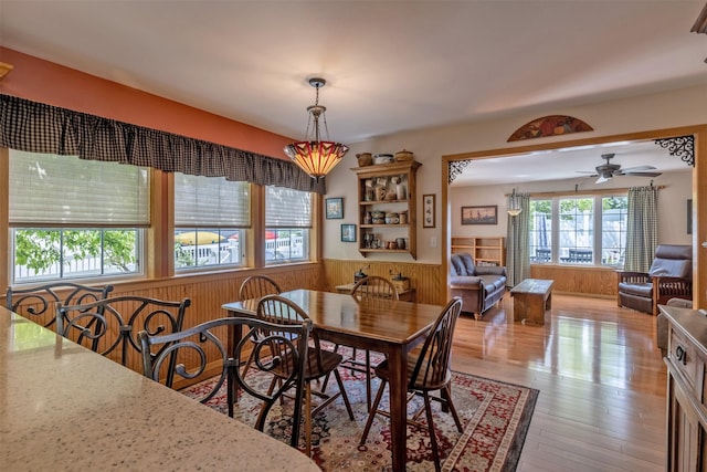 845 S California St, Helena, MT 59601 - dining space with a wainscoted wall, wood walls, ceiling fan, and wood finished floors