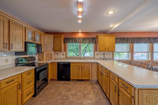 845 S California St, Helena, MT 59601 - kitchen with black appliances, a peninsula, decorative backsplash, light stone counters, and beam ceiling