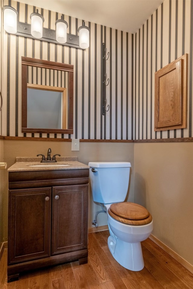 845 S California St, Helena, MT 59601 - bathroom with vanity, wood finished floors, and wallpapered walls