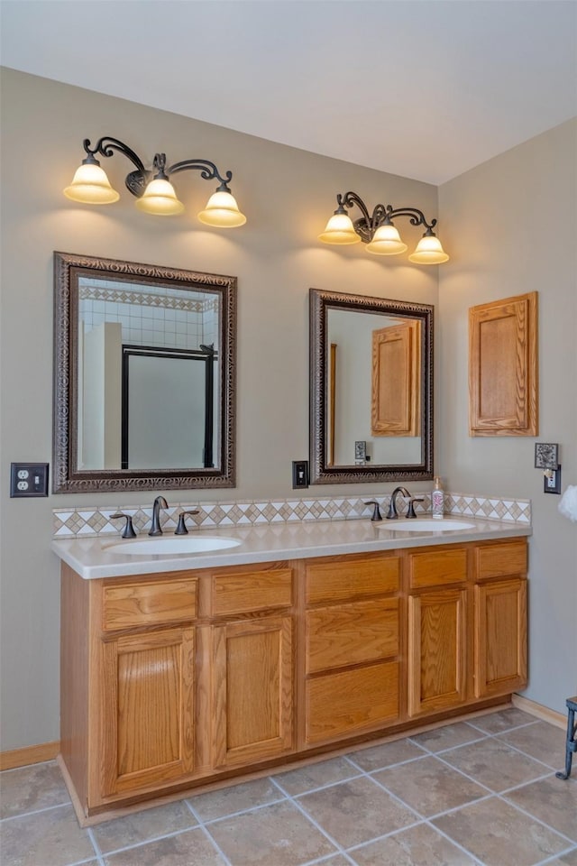 full bath with double vanity, tile patterned flooring, tasteful backsplash, and a sink