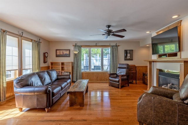 845 S California St, Helena, MT 59601 - living area with a glass covered fireplace, light wood-type flooring, a wainscoted wall, a ceiling fan, and recessed lighting