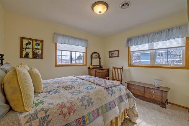 bedroom featuring light carpet, visible vents, and baseboards