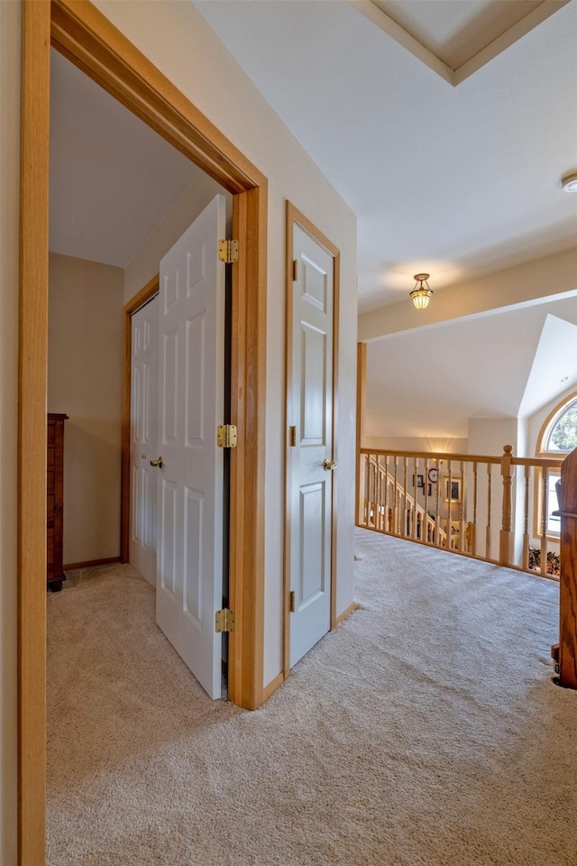 hall with baseboards and carpet