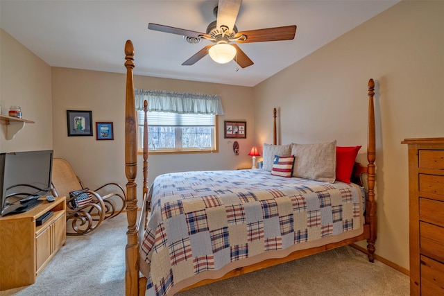 carpeted bedroom featuring a ceiling fan and baseboards