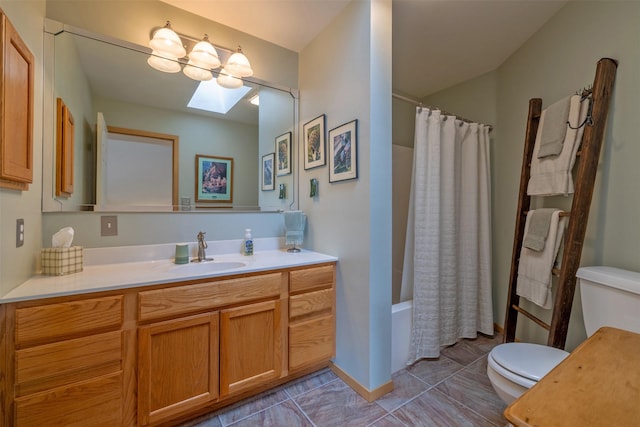 bathroom featuring toilet, a skylight, tile patterned floors, vanity, and shower / bathtub combination with curtain