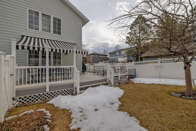 view of side of property with a deck, a yard, and fence