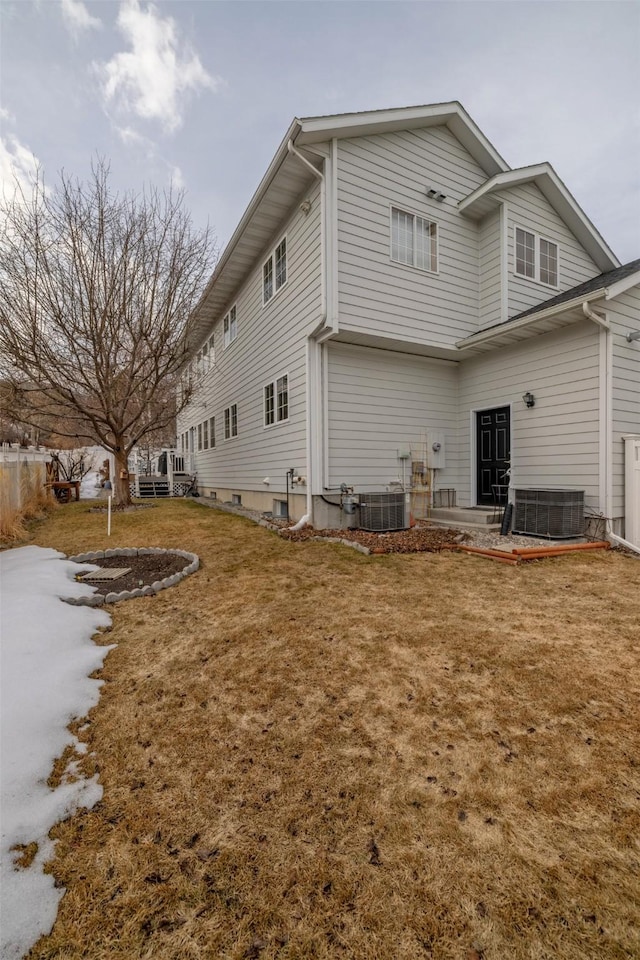 back of property featuring a patio, central air condition unit, and a yard