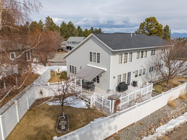 back of house with outdoor dining space, a fenced backyard, and roof with shingles